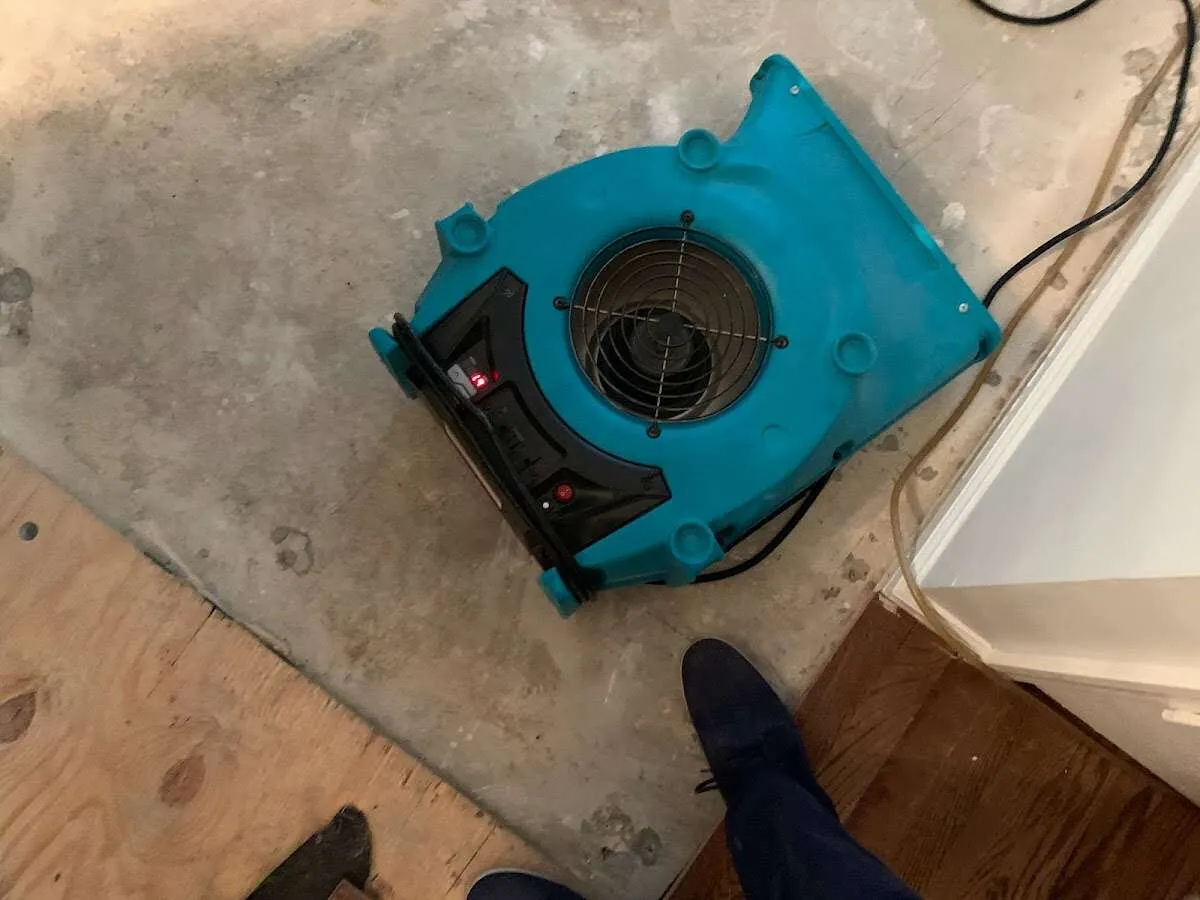 Air mover drying subfloor during Commercial Water Damage Restoration in St. Helens